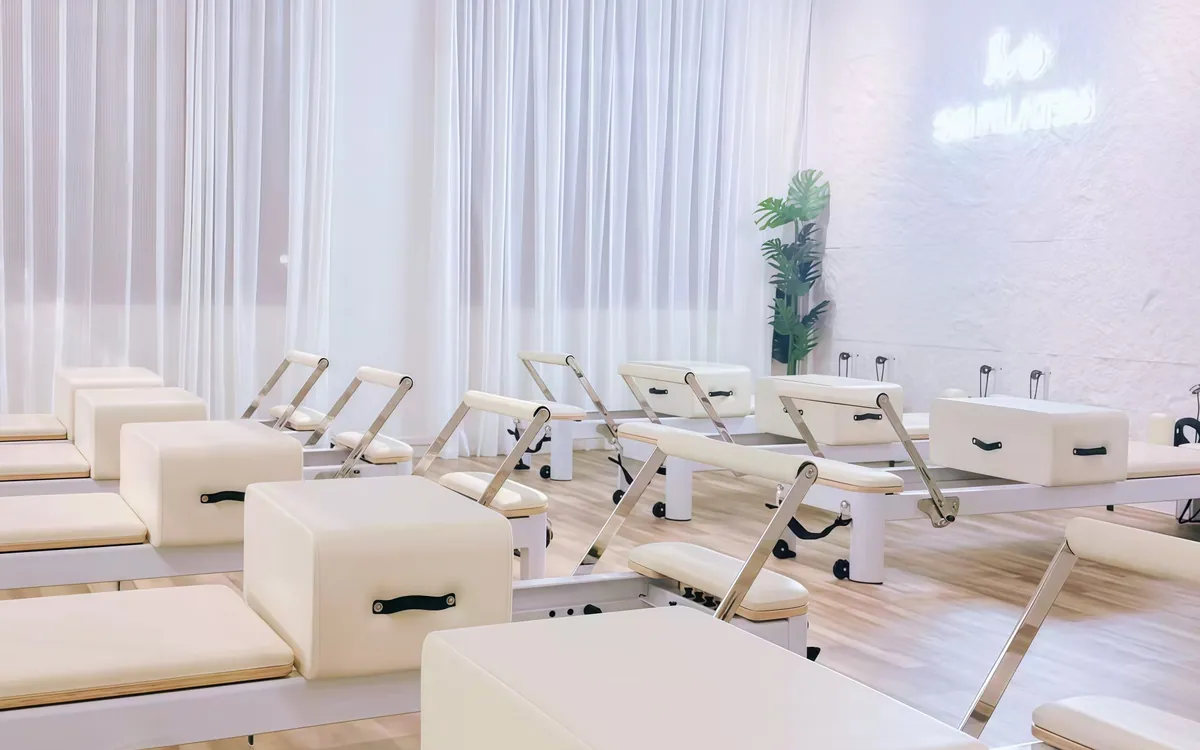 Cream reformers in a bright room at SG Pilates Great World